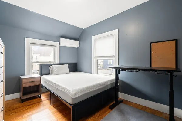 a bedroom with a bed and window