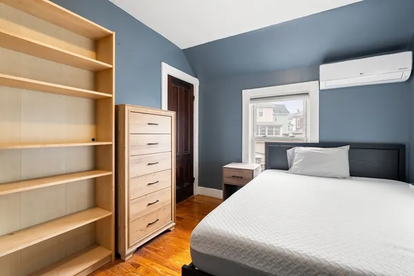 a bedroom with a bed and a window