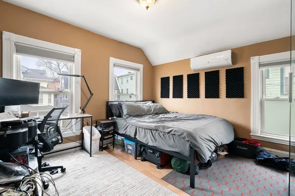 a bedroom with a bed table and a window