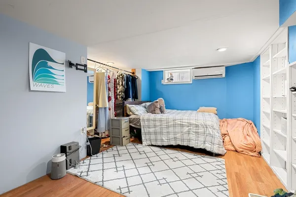a bedroom with furniture and lounge chair