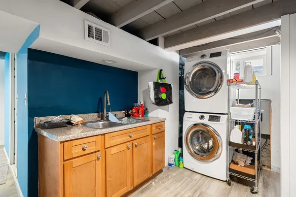 a utility room with sink dryer and washer