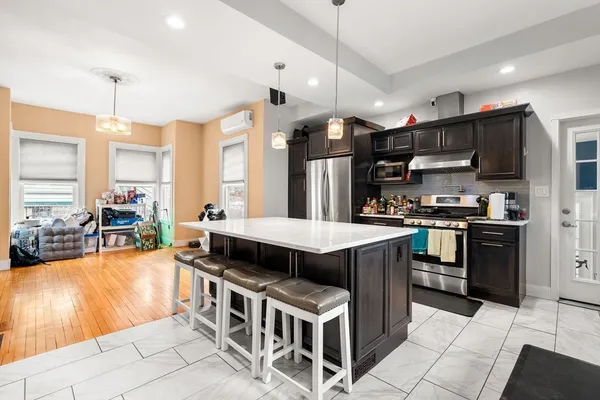 a kitchen with stainless steel appliances granite countertop a stove top oven a sink a counter top space and cabinets