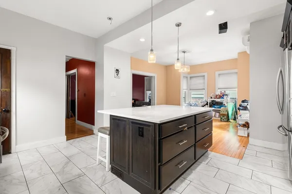 a kitchen with a stove a refrigerator and a sink