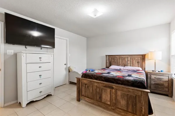 a bedroom with a bed and a view of kitchen
