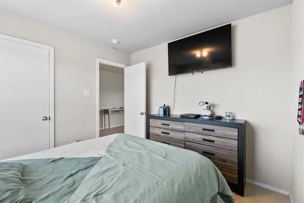 a bedroom with a bed and a flat screen tv