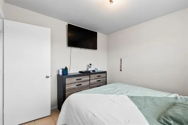 a bedroom with a bed and a television