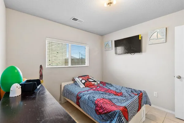 a bedroom with a bed and a dresser in it