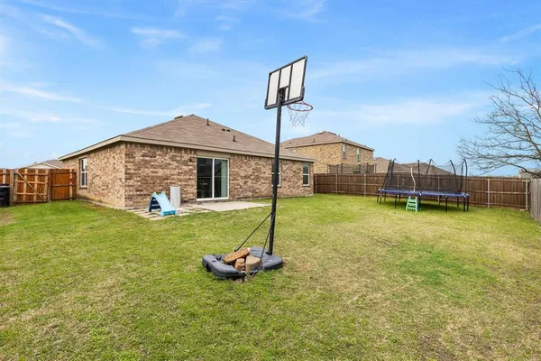 an aerial view of a house with swimming pool and a garden