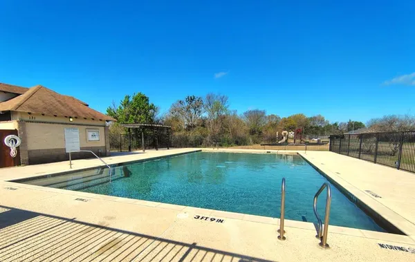 swimming pool view with a seating space