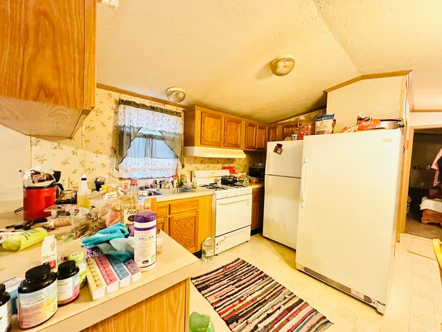 a kitchen with a sink appliances and cabinets