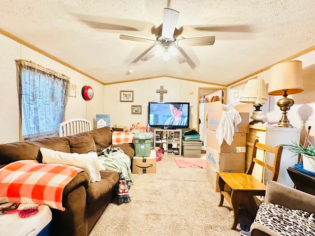 a bedroom with furniture and a flat screen tv