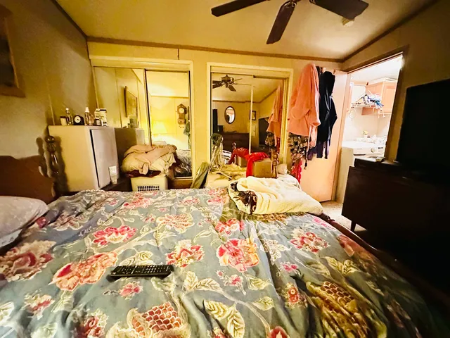 a bedroom with a bed and wooden floor