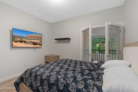 a bedroom with a large bed and a large window