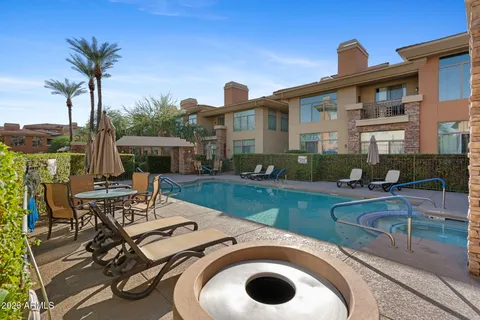 a view of a house with swimming pool and furniture
