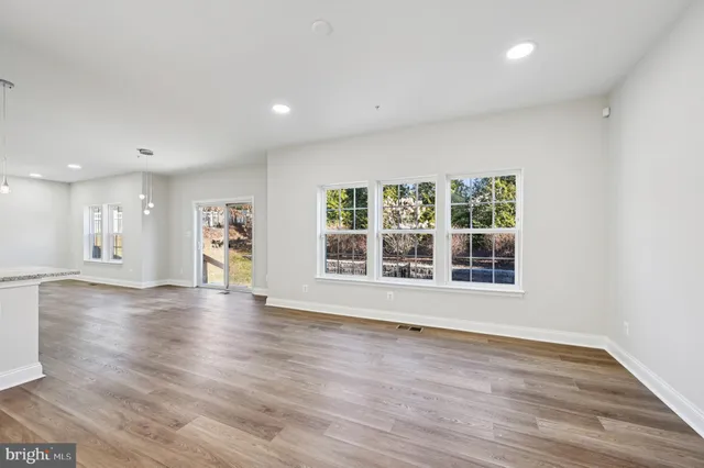 a kitchen with kitchen island granite countertop appliances cabinets and a sink