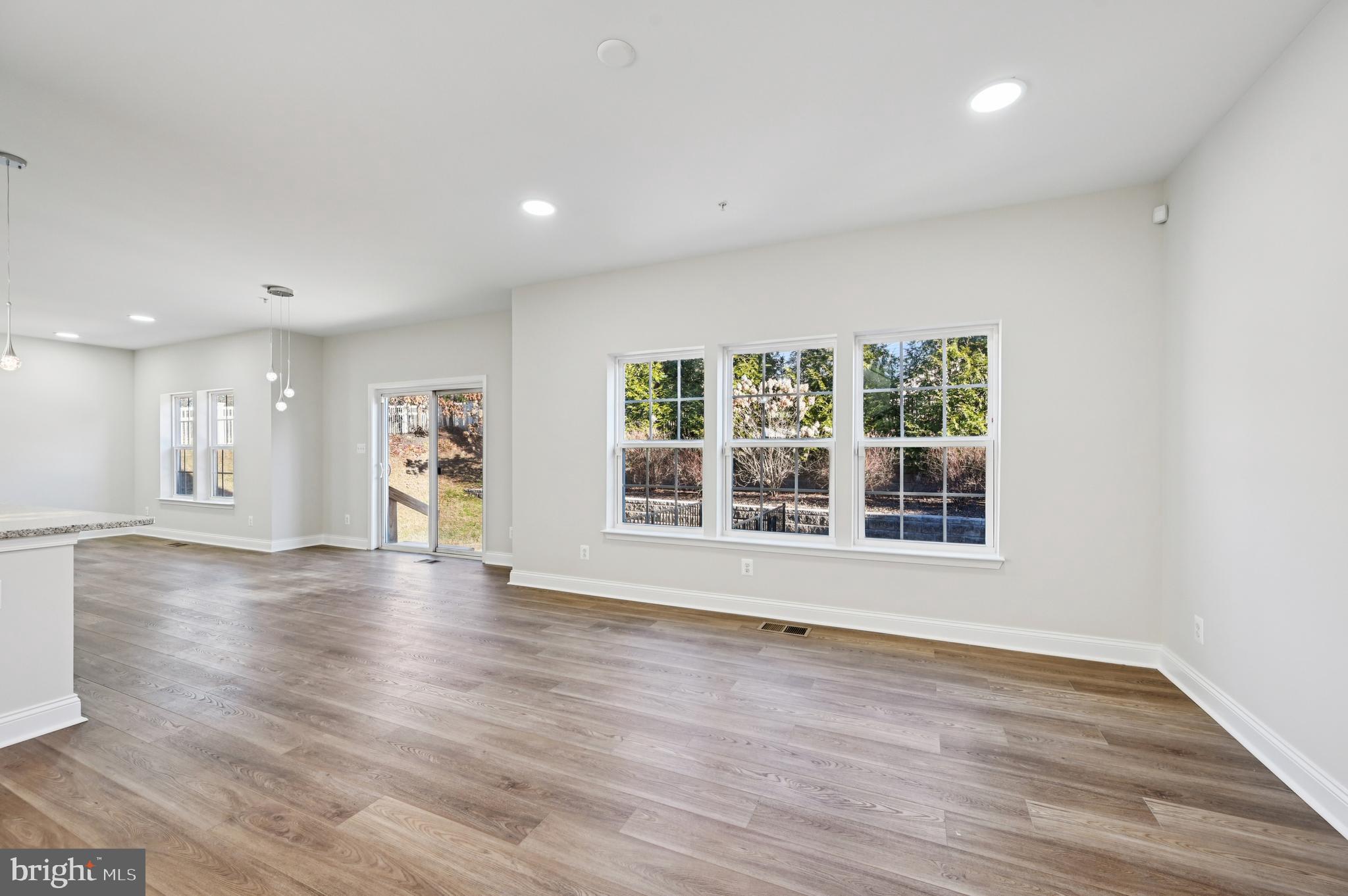 6305 Winters Lane Hanover, MD 21076 - Photo 18 of 83 a view of an empty room with wooden floor and a window
