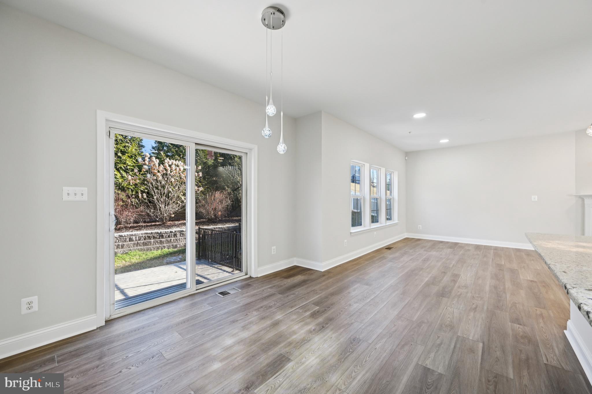 6305 Winters Lane Hanover, MD 21076 - Photo 21 of 83 a view of an empty room with wooden floor and a window