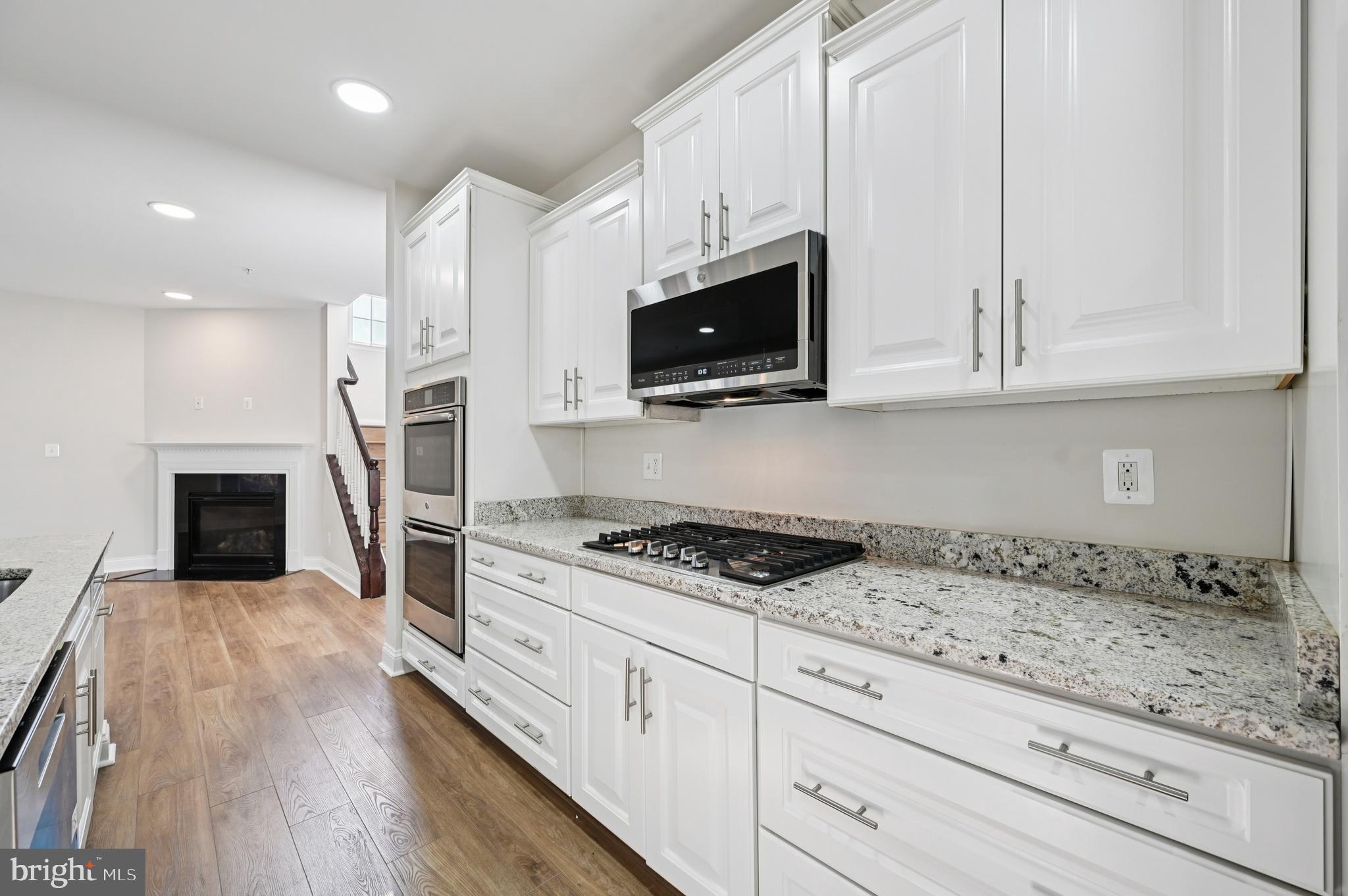 6305 Winters Lane Hanover, MD 21076 - Photo 28 of 83 a kitchen with granite countertop white cabinets and stainless steel appliances