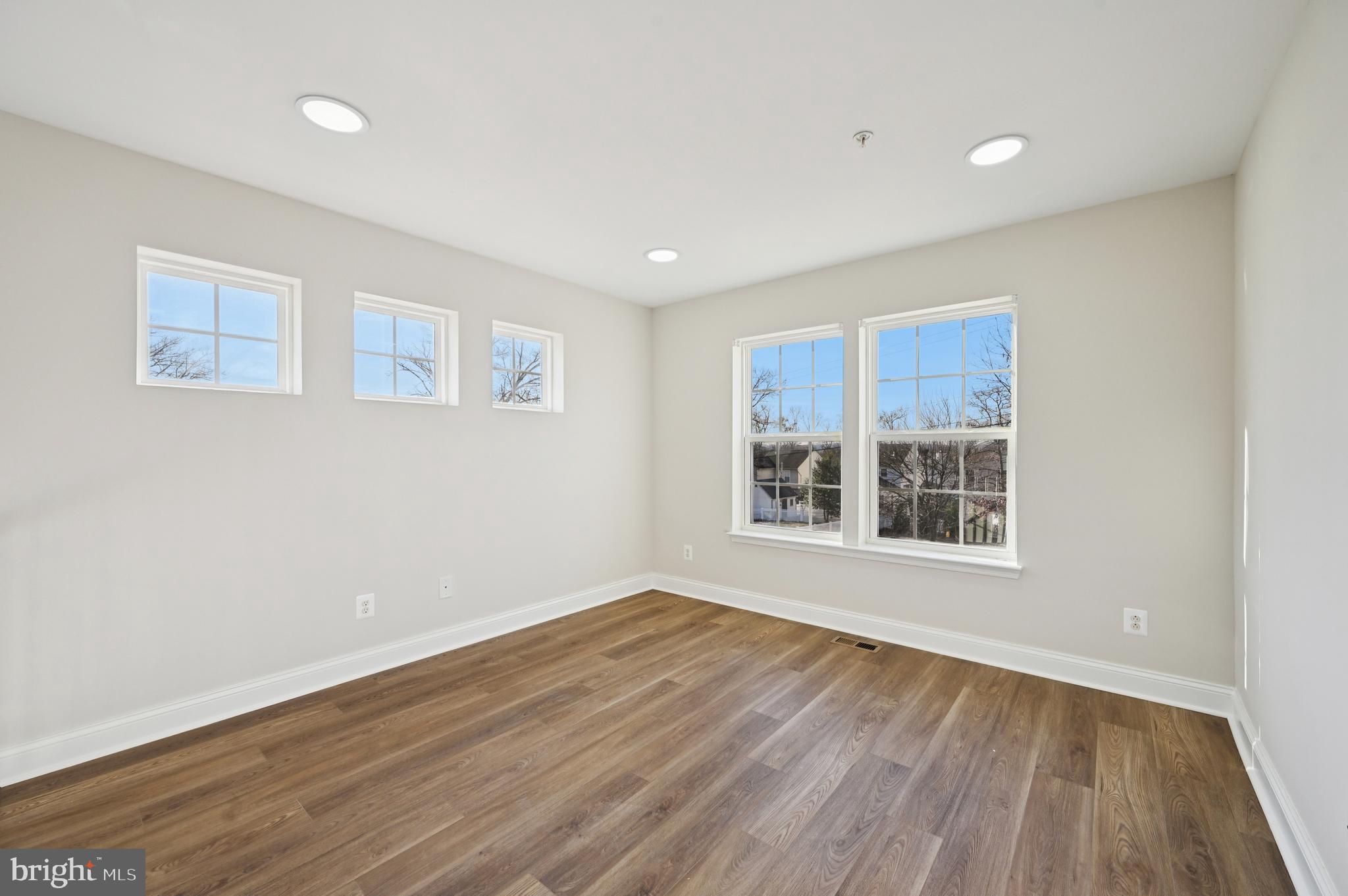 6305 Winters Lane Hanover, MD 21076 - Photo 34 of 83 a view of an empty room with wooden floor and a window