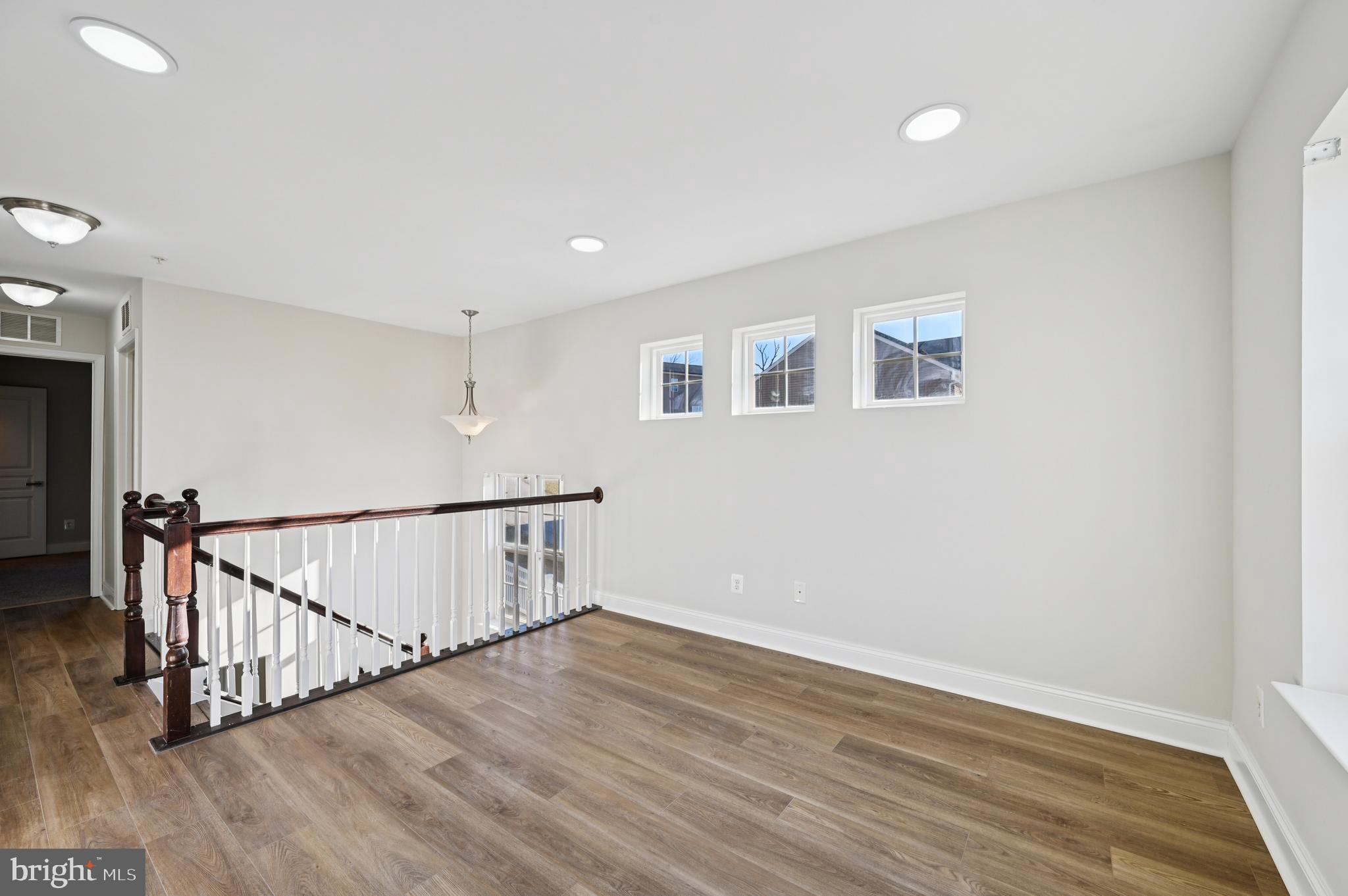 6305 Winters Lane Hanover, MD 21076 - Photo 36 of 83 a view of a hallway with wooden floor