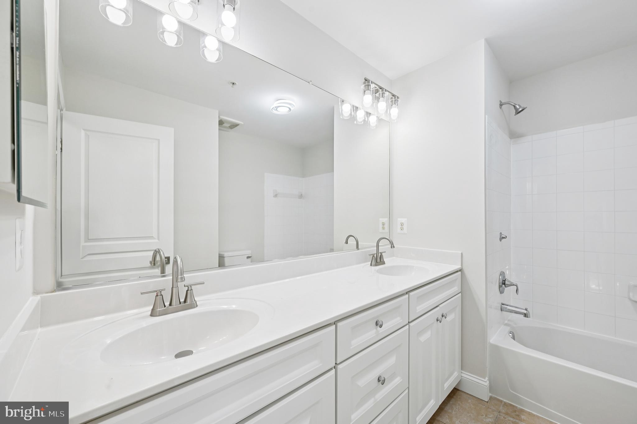 6305 Winters Lane Hanover, MD 21076 - Photo 41 of 83 a bathroom with a sink double vanity granite tub and shower