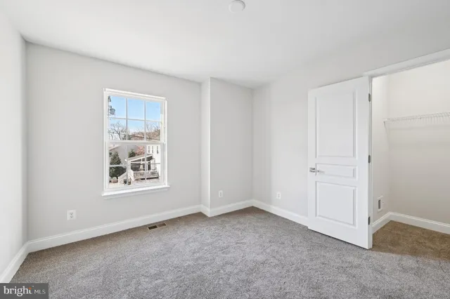a view of an empty room and a window