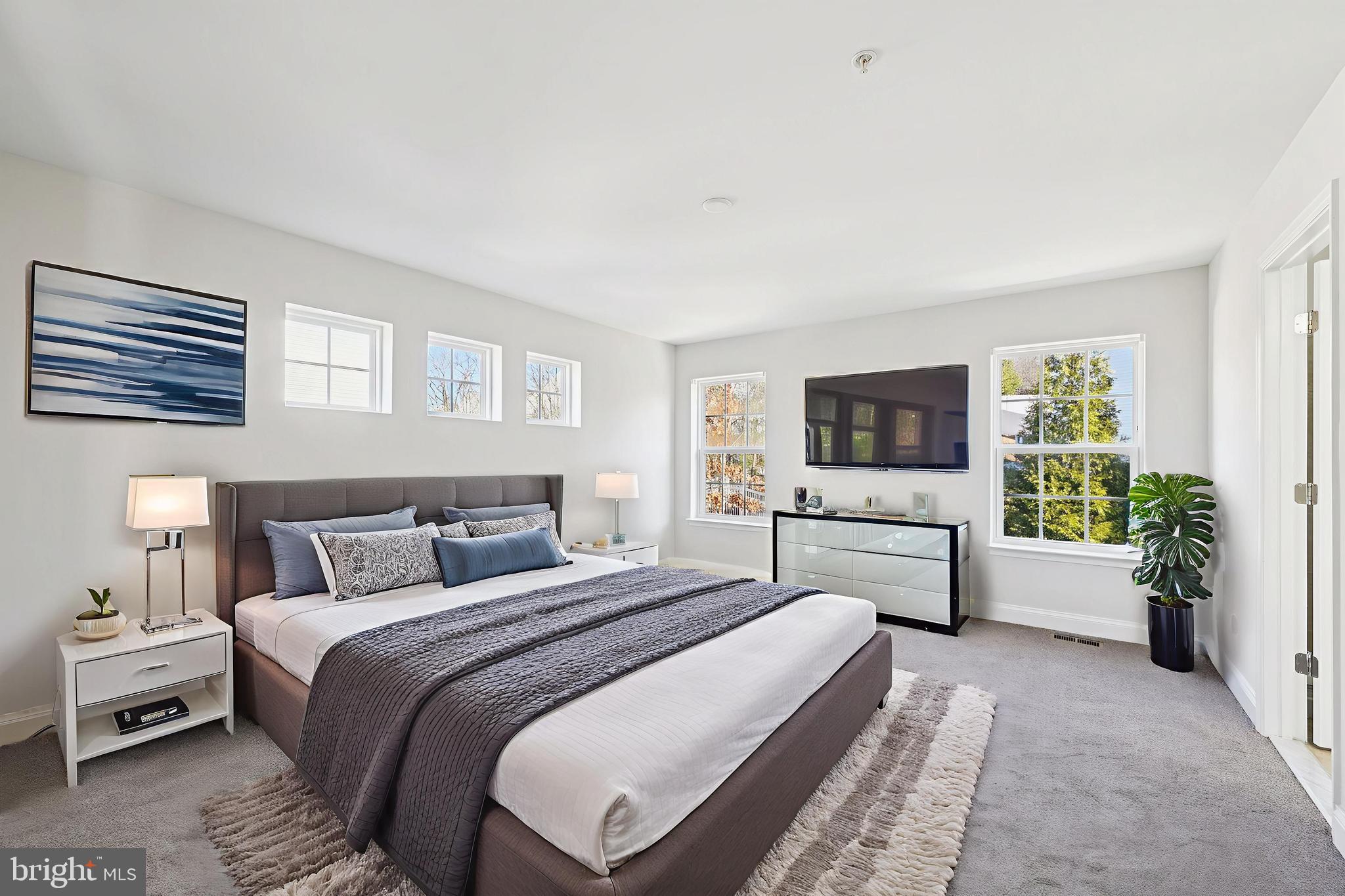 6305 Winters Lane Hanover, MD 21076 - Photo 45 of 83 a bedroom with a large bed and a flat screen tv