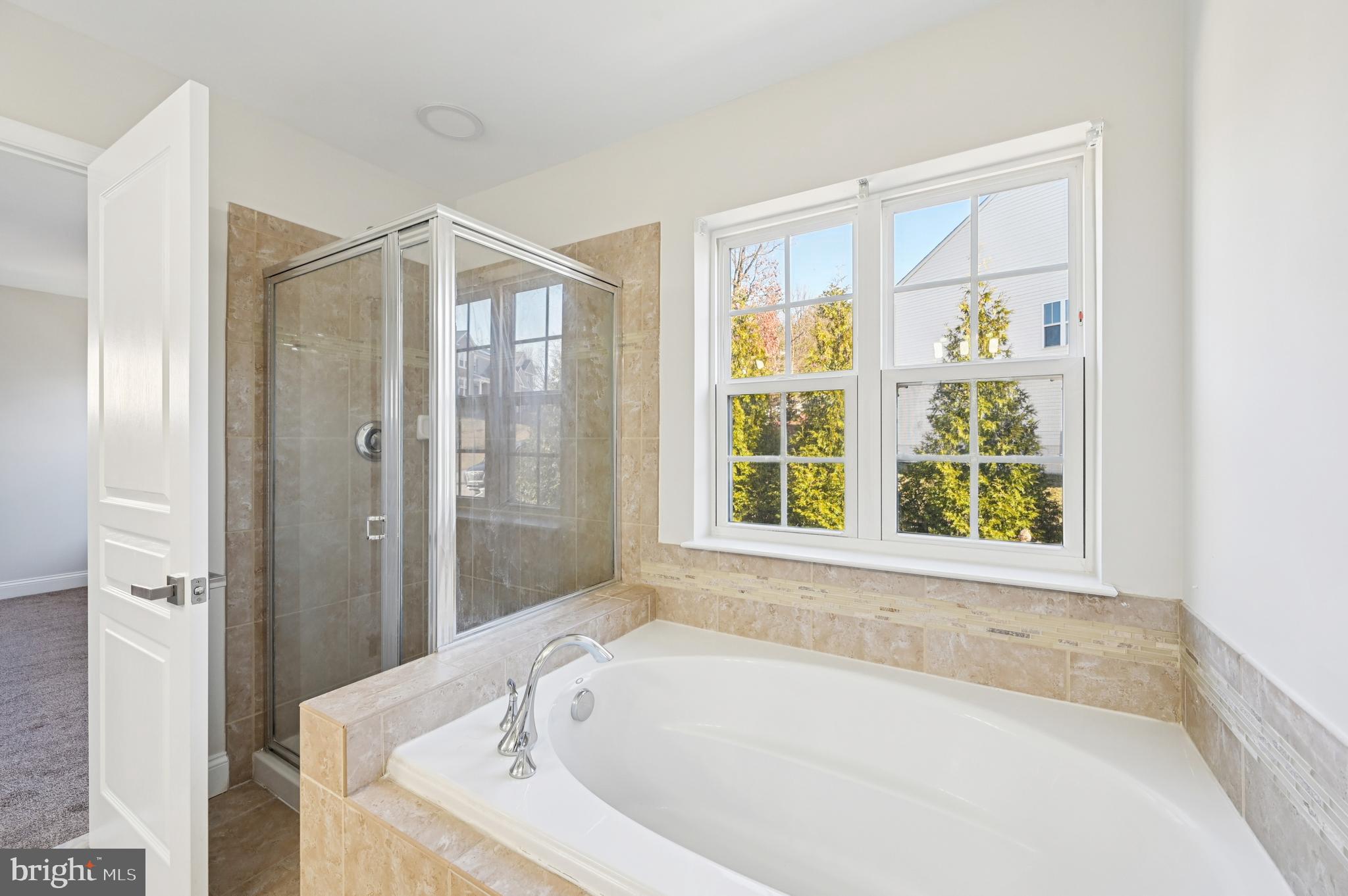 6305 Winters Lane Hanover, MD 21076 - Photo 52 of 83 a bathroom with a bathtub and a shower