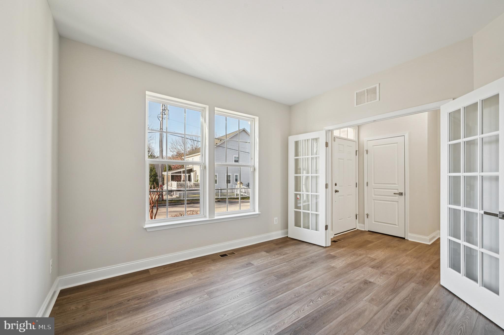 6305 Winters Lane Hanover, MD 21076 - Photo 10 of 83 an empty room with wooden floor and windows