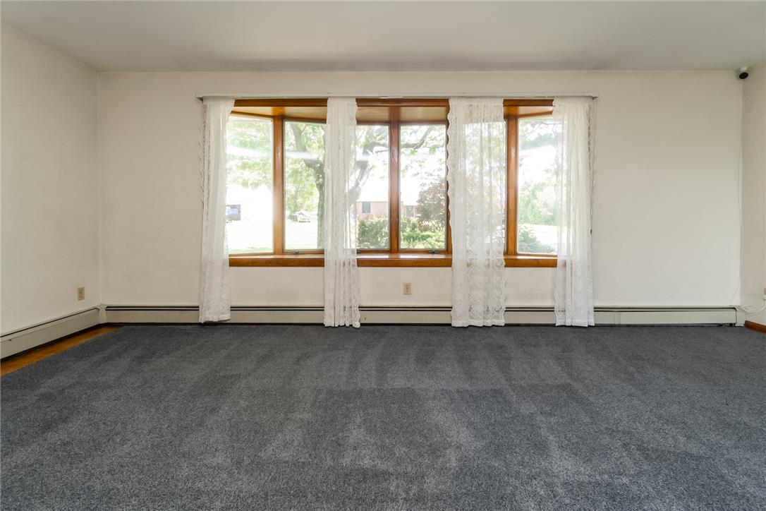 1657 Clearview Road Coplay, PA 18037 - Photo 34 of 77 A spacious room offers ample natural light through a series of windows, framed by delicate lace.