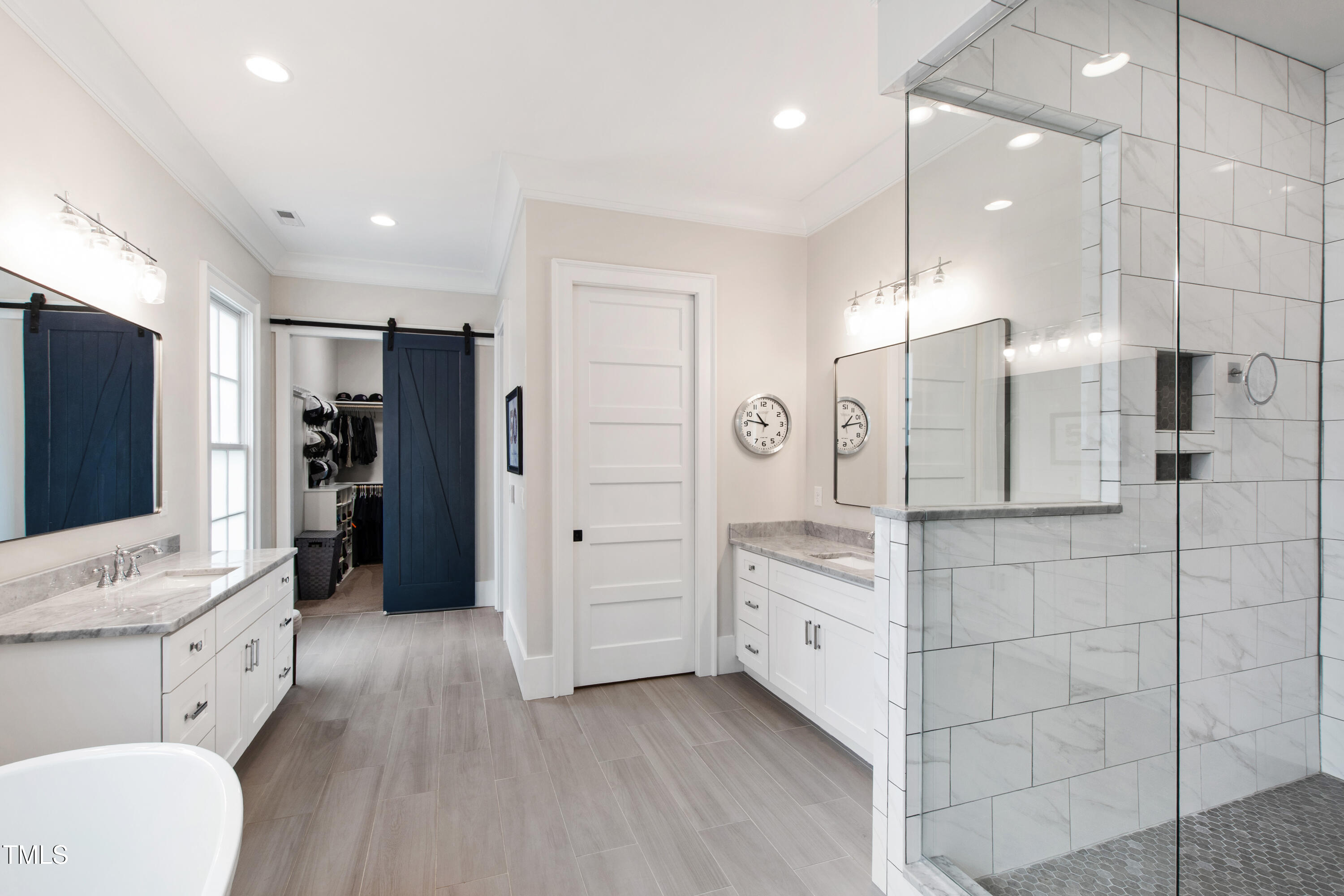 4237 Rowan Street Raleigh, NC 27609 - Photo 17 of 34 a spacious bathroom with a double vanity sink a large mirror and shower