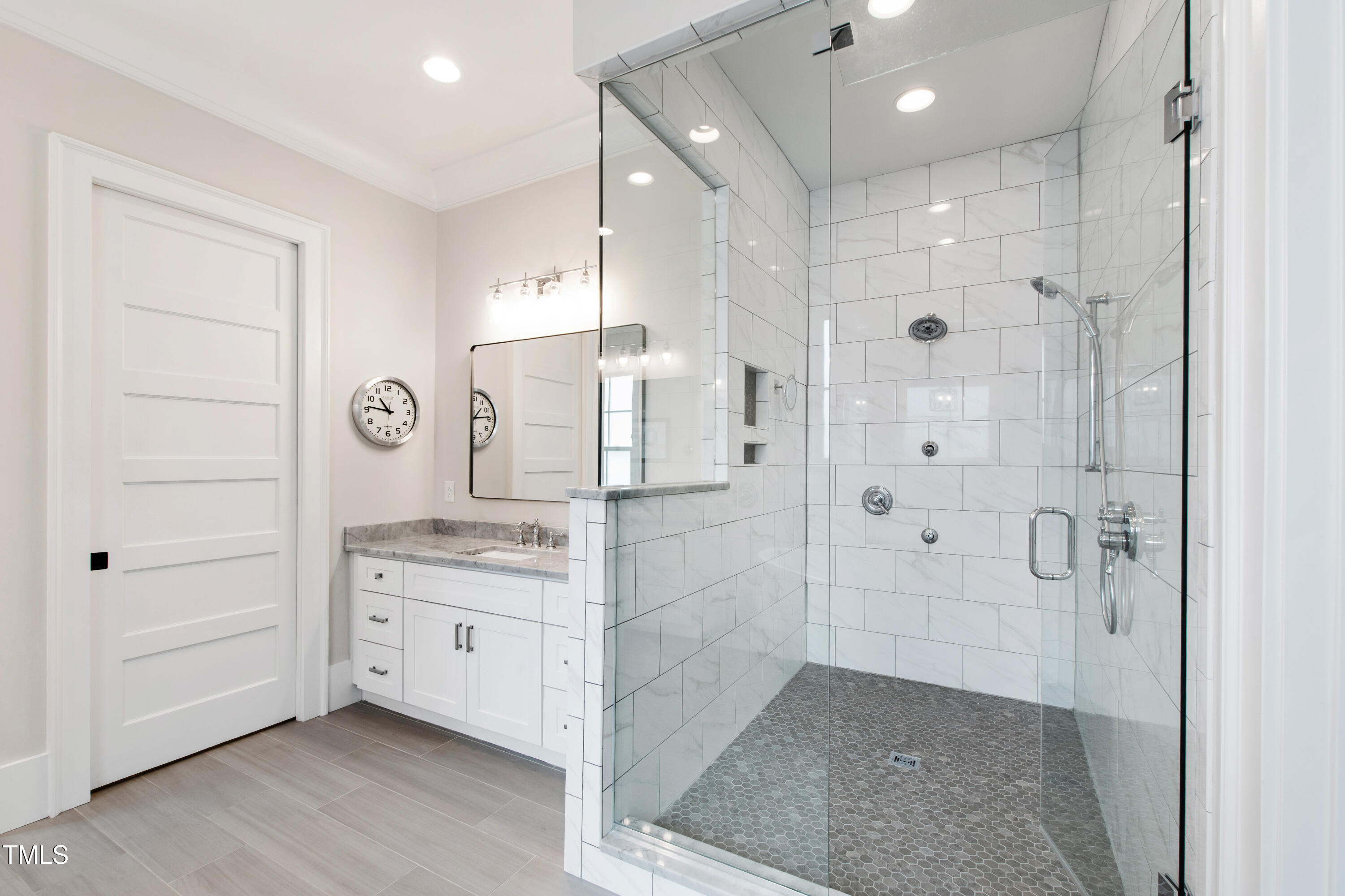 4237 Rowan Street Raleigh, NC 27609 - Photo 18 of 34 a bathroom with a granite countertop sink mirror and shower