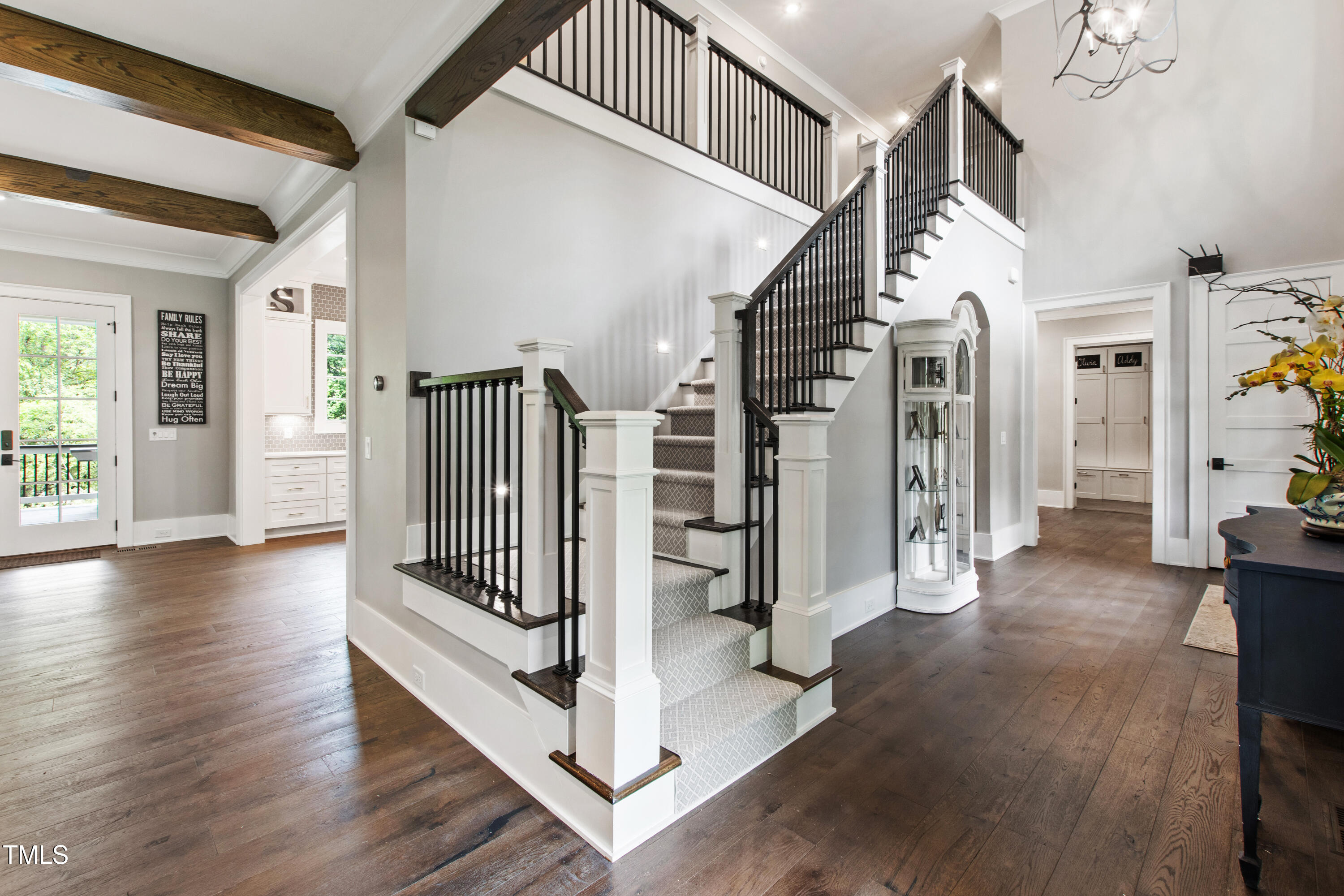 4237 Rowan Street Raleigh, NC 27609 - Photo 22 of 34 a view of entryway with stairs and wooden floor