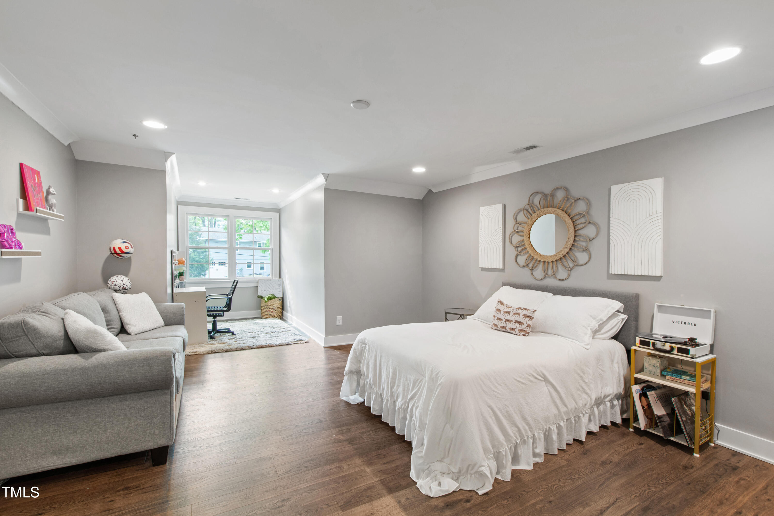 4237 Rowan Street Raleigh, NC 27609 - Photo 24 of 34 a bedroom with a bed and wooden floor