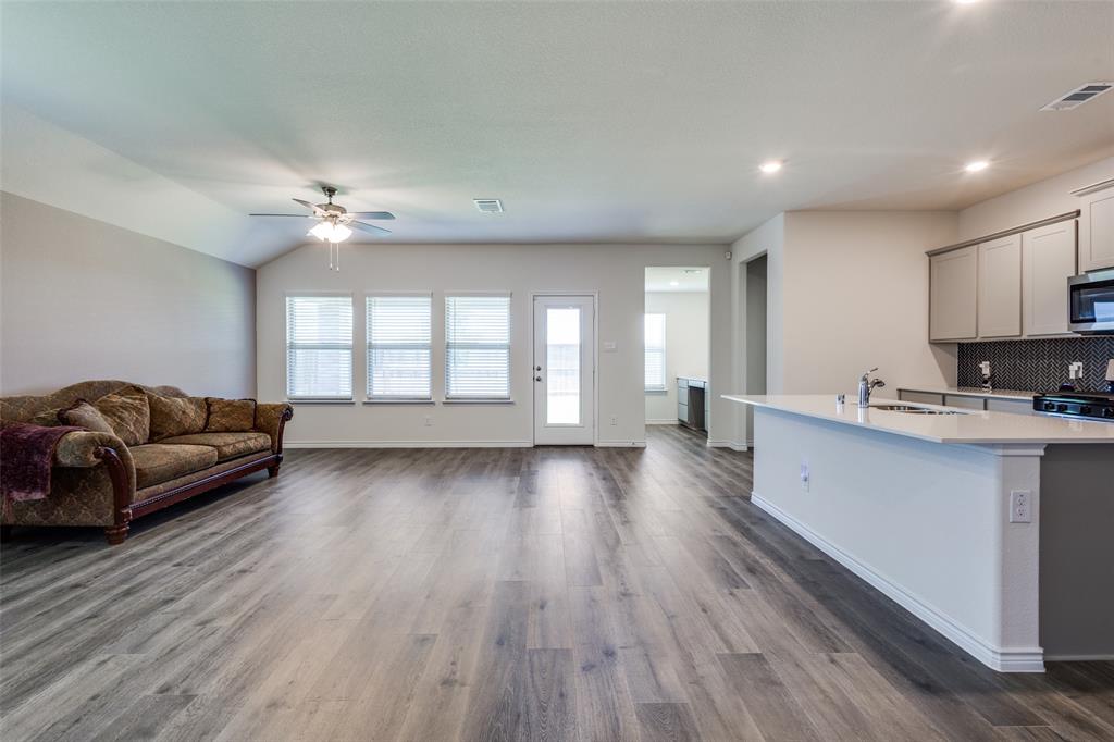 6213 Abby Drive Aubrey, TX 76227 - Photo 32 of 32 a living room with hard wood floors and furniture or wooden floor