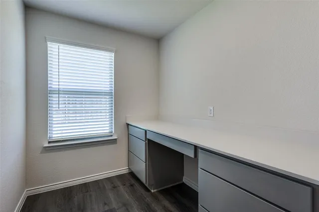 a view of kitchen with kitchen island stainless steel appliances cabinets and wooden floor