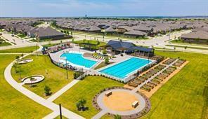 6213 Abby Drive Aubrey, TX 76227 - Photo 2 of 32 a view of a swimming pool with a table and chairs