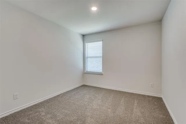 a bathroom with a granite countertop toilet and a sink