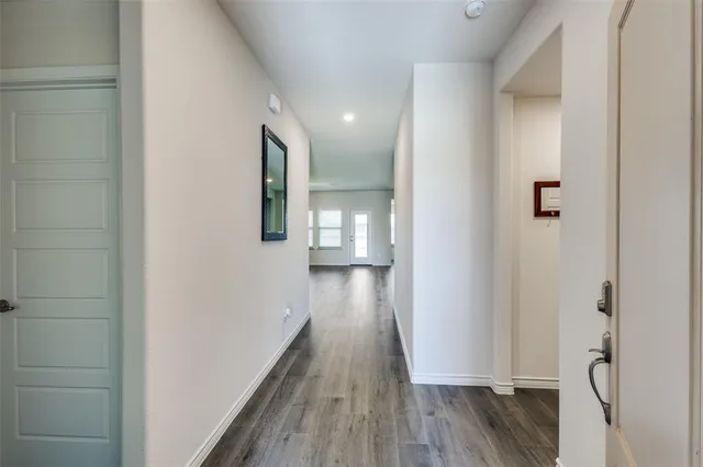 a view of hallway with wooden floor