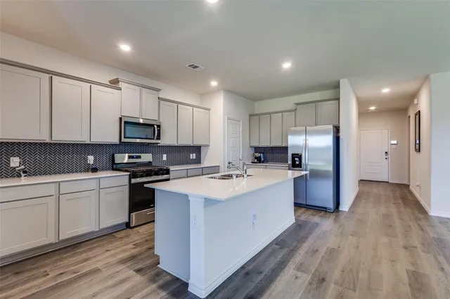 a kitchen with sink and cabinets