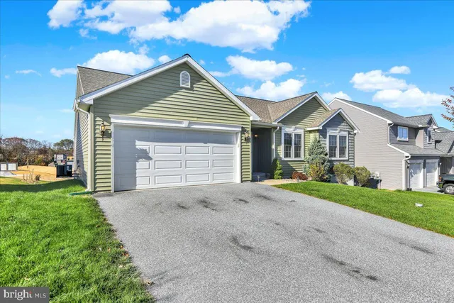 a view of a house with a yard and garage