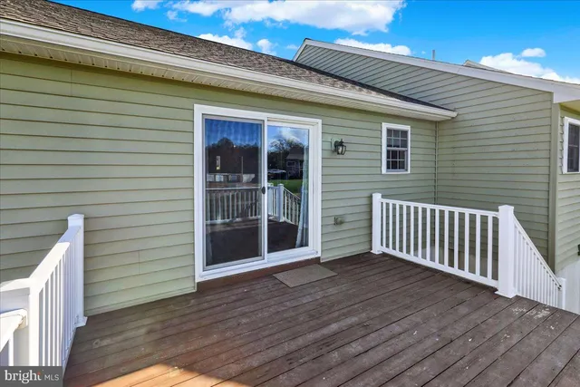 a view of a deck with wooden floor and fence