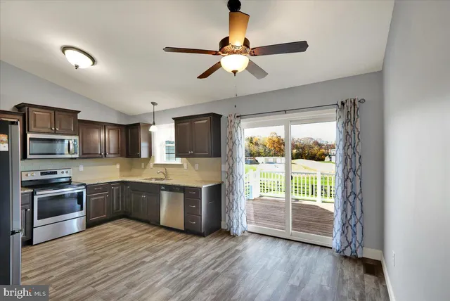 a kitchen with stainless steel appliances granite countertop a stove and a sink