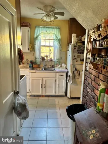 a kitchen with stainless steel appliances a stove a sink and a refrigerator