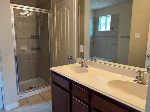 a bath tub sitting in a bathroom next to a window