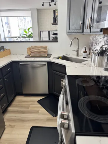 a kitchen with a sink cabinets and a wooden floor