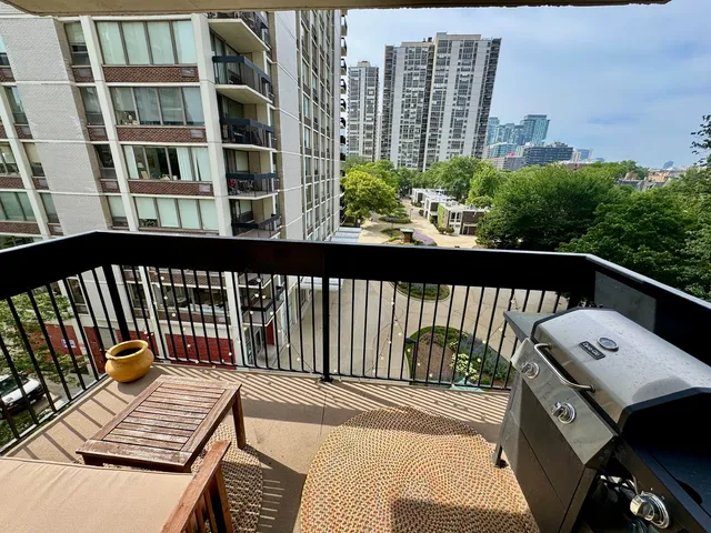 a view of a balcony with wooden floor and city view