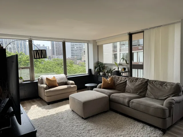 a living room with furniture and a large window