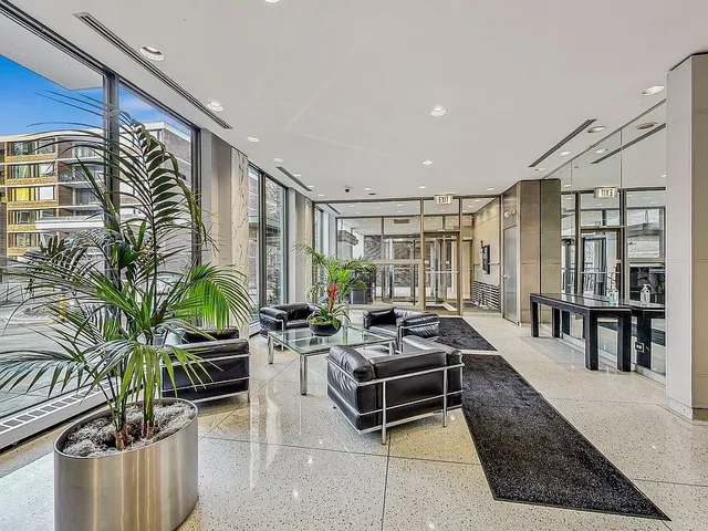 a lobby with furniture and floor to ceiling window