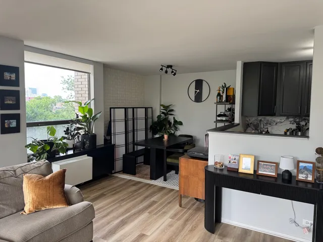 a living room with furniture window and wooden floor